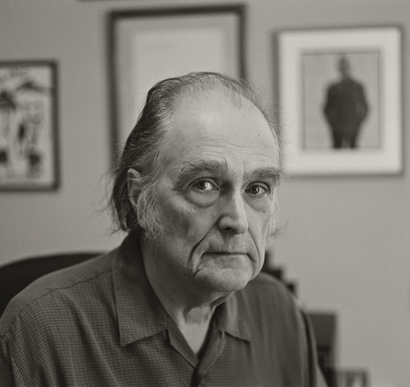 Older white man with longer hair, black and white photo. 